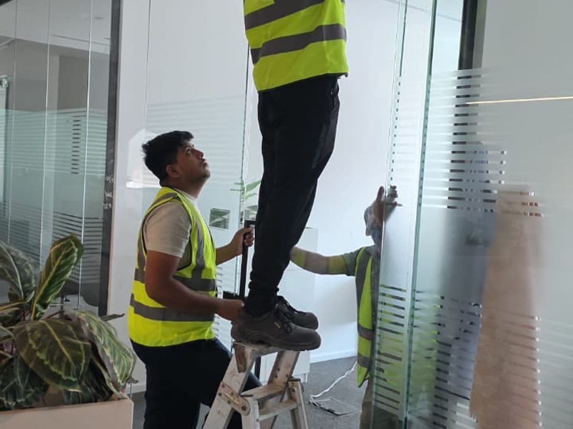 Pillarstone installation crew fitting glass partitions on site in the UAE