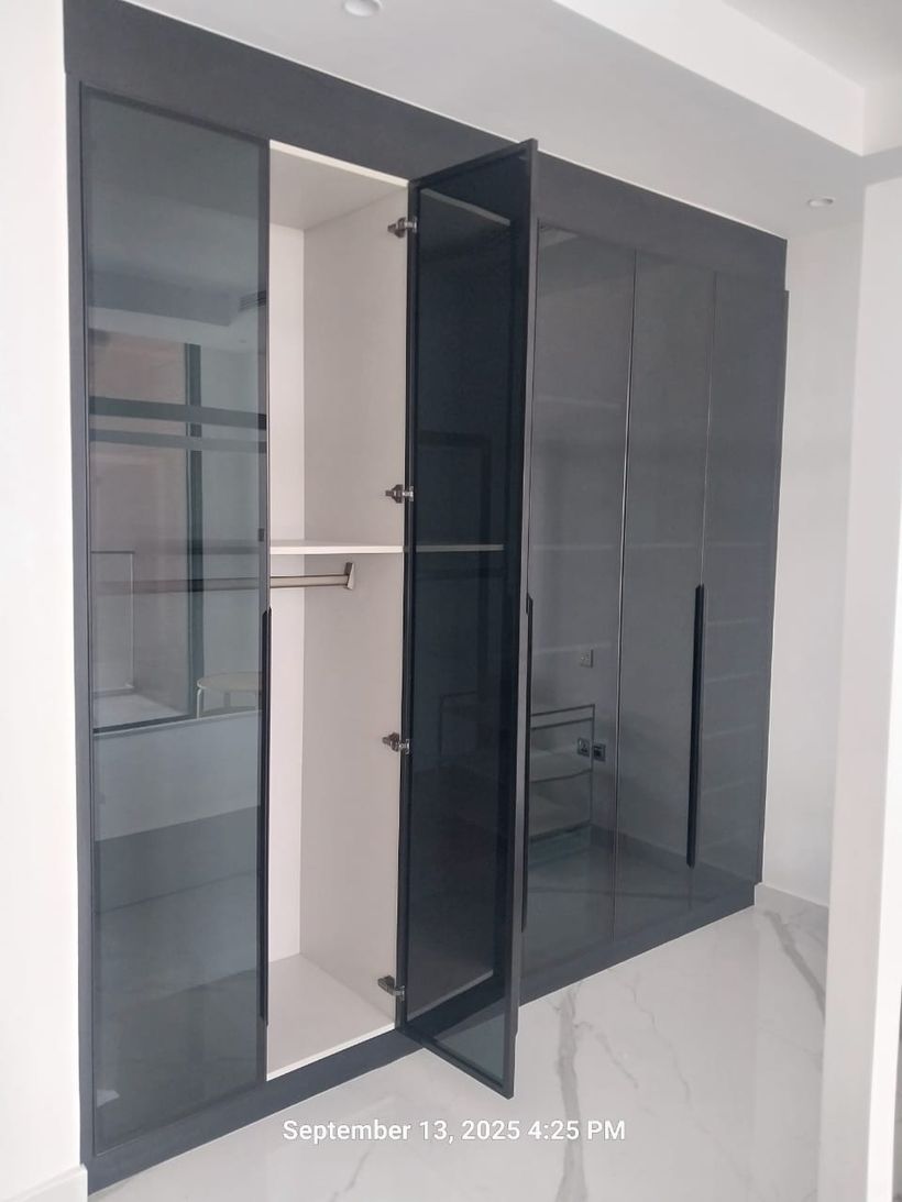 Smoked-glass wardrobe by Pillarstone in the UAE